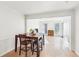 Open-concept dining room flowing into the living room, featuring hardwood floors and lots of natural light at 4506 Reva Ne Way, Marietta, GA 30066