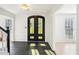 Bright foyer features dark tile flooring, a black front door, and views of the staircase at 4506 Reva Ne Way, Marietta, GA 30066