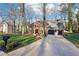 Brick home with a driveway and two-car garage, surrounded by mature trees and a well-groomed lawn at 4506 Reva Ne Way, Marietta, GA 30066