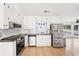 Well-equipped kitchen featuring white cabinets, stainless steel appliances, granite countertops, and hardwood floors at 4506 Reva Ne Way, Marietta, GA 30066