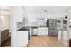 Well-lit kitchen with stainless steel appliances, subway tile backsplash, and white cabinets, connecting to a bathroom at 4506 Reva Ne Way, Marietta, GA 30066