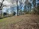 Home surrounded by trees with sloping backyard providing natural scenery at 712 Copper Trace Way, Woodstock, GA 30189