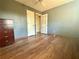 Bedroom featuring wood-look floors, a ceiling fan, and a door at 712 Copper Trace Way, Woodstock, GA 30189