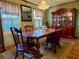 Elegant dining room featuring a wooden table and chairs, china cabinet, and soft window lighting at 712 Copper Trace Way, Woodstock, GA 30189