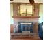 Close-up of brick fireplace with wooden mantel and decorative mirror in the living room at 712 Copper Trace Way, Woodstock, GA 30189