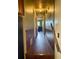 Hallway with wood-look flooring and wainscoting, connecting various areas of the home at 712 Copper Trace Way, Woodstock, GA 30189