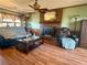 Cozy living room with brick fireplace, ceiling fan, and wood-look flooring for comfortable living at 712 Copper Trace Way, Woodstock, GA 30189