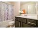 Cozy bathroom with a tub and shower combination and dark wood vanity at 7808 Rutgers Cir, Fairburn, GA 30213