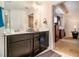 Well-lit bathroom featuring a double sink vanity and a view to the primary bedroom at 7808 Rutgers Cir, Fairburn, GA 30213