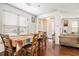 Bright dining area featuring hardwood floors and a view into the living room at 7808 Rutgers Cir, Fairburn, GA 30213