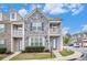 Charming townhome featuring stone and siding, complemented by a well-manicured lawn at 7808 Rutgers Cir, Fairburn, GA 30213