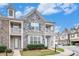 Beautiful townhome with stone accents and a well-maintained lawn at 7808 Rutgers Cir, Fairburn, GA 30213