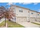 Exterior of the townhome with a two-car garage, driveway and grassy area at 7808 Rutgers Cir, Fairburn, GA 30213