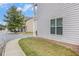 Exterior shot of home with a grassy area and landscaping along the sidewalk at 7808 Rutgers Cir, Fairburn, GA 30213