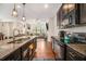 Open kitchen flowing into the living room with granite countertops and stainless steel appliances at 7808 Rutgers Cir, Fairburn, GA 30213