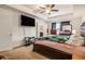 Another view of the main bedroom with a large bed, TV, ceiling fan, and ample natural light at 7808 Rutgers Cir, Fairburn, GA 30213