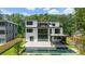The house boasts a swimming pool, hot tub, outdoor kitchen, balconies, and floor to ceiling glass windows at 1291 Sunderland Ct, Atlanta, GA 30319