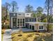 Striking home with a modern design featuring a flat roof, large windows, and a spacious driveway at 1291 Sunderland Ct, Atlanta, GA 30319