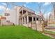 The backyard features a multi-level deck, lush green lawn, and partial view of a pool, creating an inviting outdoor space at 2125 Datona Sw Dr, Atlanta, GA 30331