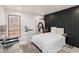 Bedroom featuring a black accent wall, ample natural light, and stylish decor at 2125 Datona Sw Dr, Atlanta, GA 30331