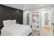 Bedroom featuring a black accent wall, ample natural light, and stylish decor at 2125 Datona Sw Dr, Atlanta, GA 30331