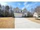 Inviting two-story home with board and batten siding, featuring an attached two-car garage and spacious front yard at 4825 Marco Ln, Cumming, GA 30028