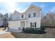 Charming home with board and batten siding, a two-car garage, complemented by meticulously arranged flowerbeds at 4825 Marco Ln, Cumming, GA 30028