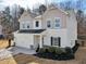 Charming two-story home featuring a two-car garage, well-manicured lawn, and neutral paint scheme at 4825 Marco Ln, Cumming, GA 30028