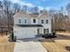 Charming two-story home featuring a two-car garage, well-manicured lawn, and neutral paint scheme at 4825 Marco Ln, Cumming, GA 30028