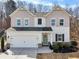 Charming two-story home featuring a two-car garage, well-manicured lawn, and neutral paint scheme at 4825 Marco Ln, Cumming, GA 30028