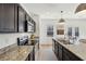 Modern kitchen featuring granite countertops, stainless steel appliances, and dark wood cabinetry at 4825 Marco Ln, Cumming, GA 30028