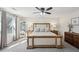 Spacious main bedroom featuring hardwood bed and neutral colored walls and coverings at 4825 Marco Ln, Cumming, GA 30028