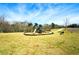 Community playground featuring a modern play structure, mulch ground cover, benches, and set in a large grassy area at 4825 Marco Ln, Cumming, GA 30028