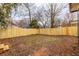 Backyard view of a wood fence with a grass and dirt yard at 973 Parsons Sw St, Atlanta, GA 30314