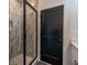 Contemporary bathroom featuring a glass shower, black door, and neutral colored walls, with updated fixtures at 973 Parsons Sw St, Atlanta, GA 30314