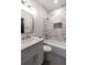 Stylish bathroom featuring a tiled shower, vanity with bronze fixtures and gray tiled floor at 973 Parsons Sw St, Atlanta, GA 30314