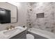 Bright bathroom featuring marble-style tiled walls, bronze fixtures, and a black framed mirror at 973 Parsons Sw St, Atlanta, GA 30314