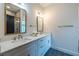 Bright bathroom with dual sinks, quartz countertops, modern fixtures, and sleek hexagon tile flooring at 973 Parsons Sw St, Atlanta, GA 30314