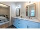 Chic bathroom featuring a double vanity, neutral colored walls, marble countertops, and access to the bedroom at 973 Parsons Sw St, Atlanta, GA 30314