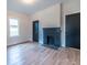 Bedroom featuring hardwood floors, a brick fireplace, neutral walls, and lots of natural light at 973 Parsons Sw St, Atlanta, GA 30314