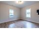 Empty bedroom features natural lighting, hardwood floors, neutral colored walls, and a view from the windows at 973 Parsons Sw St, Atlanta, GA 30314