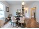 Charming dining area with unique light fixture, fireplace, hardwood floors, and a cozy atmosphere at 973 Parsons Sw St, Atlanta, GA 30314