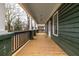 Spacious front porch with natural wood flooring and a view of the neighborhood at 973 Parsons Sw St, Atlanta, GA 30314