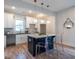 Bright kitchen with modern white cabinetry, island with counter seating, and contemporary pendant lighting at 973 Parsons Sw St, Atlanta, GA 30314