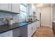 Bright kitchen showcases granite counters, white cabinetry, and a tile backsplash at 973 Parsons Sw St, Atlanta, GA 30314