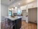 Modern kitchen featuring an island with a breakfast bar, white cabinets, and stylish pendant lights at 973 Parsons Sw St, Atlanta, GA 30314