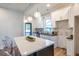 Modern kitchen featuring an island with seating, white cabinets, granite counters, and pendant lighting at 973 Parsons Sw St, Atlanta, GA 30314