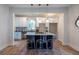 Modern kitchen island with sleek countertops, bar stools, and stylish pendant lighting in a well-lit space at 973 Parsons Sw St, Atlanta, GA 30314