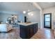 Open kitchen with island, white cabinets, granite countertops, and view to the decorated living room at 973 Parsons Sw St, Atlanta, GA 30314