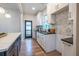 Bright kitchen featuring white cabinets, granite countertops, stainless sink, and an island with breakfast bar at 973 Parsons Sw St, Atlanta, GA 30314